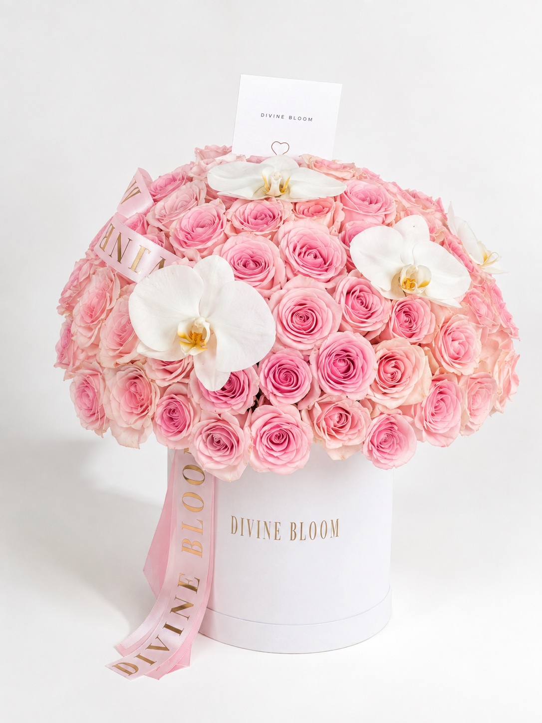 A Divine Bloom flower box with blush roses and white orchids